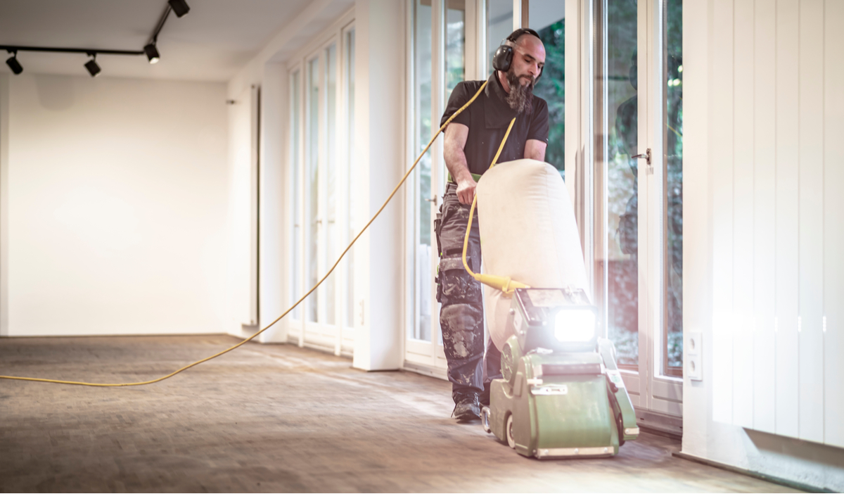 Five Common Myths About Property Restoration - man using a carpet cleaner