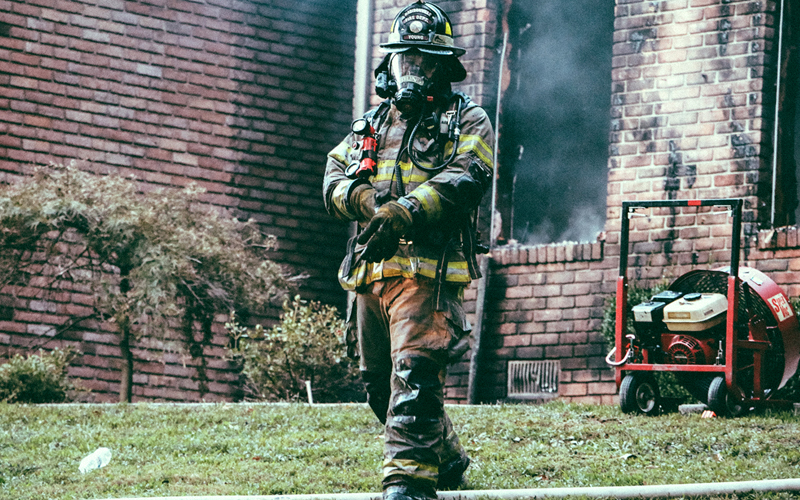 Fireman walking away from smoking house