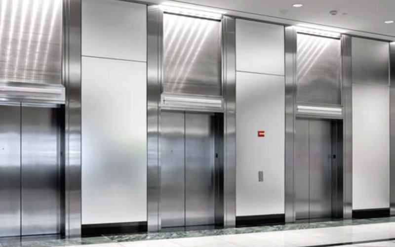 A stainless steel elevator bank